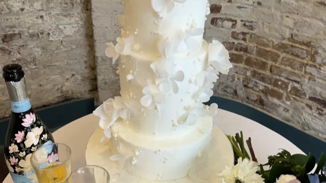 Modern wedding cake with textured fondant and wafer paper decorations