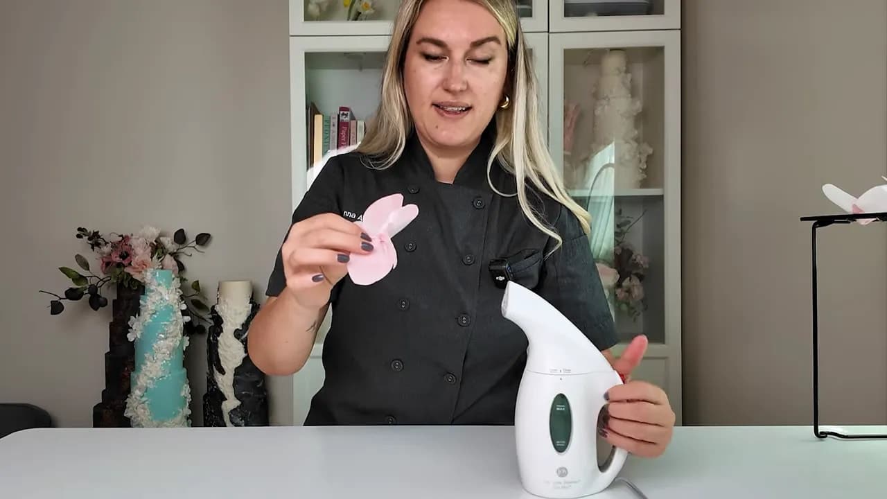 Wedding cake designer inserting the center into a wafer paper flower