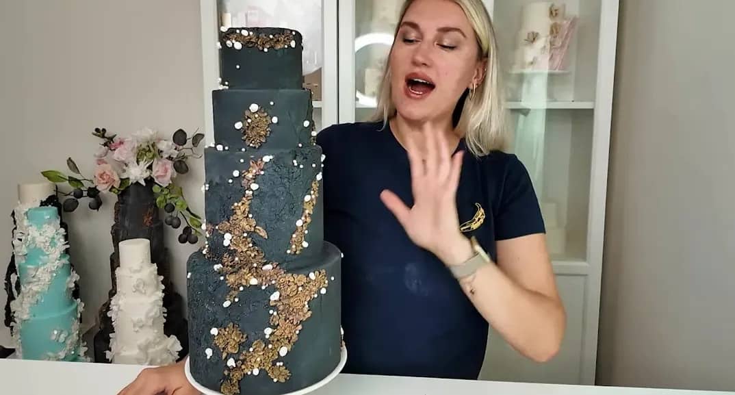 Wedding cake dummy with dark rough stone fondant texture and gold sparkle details