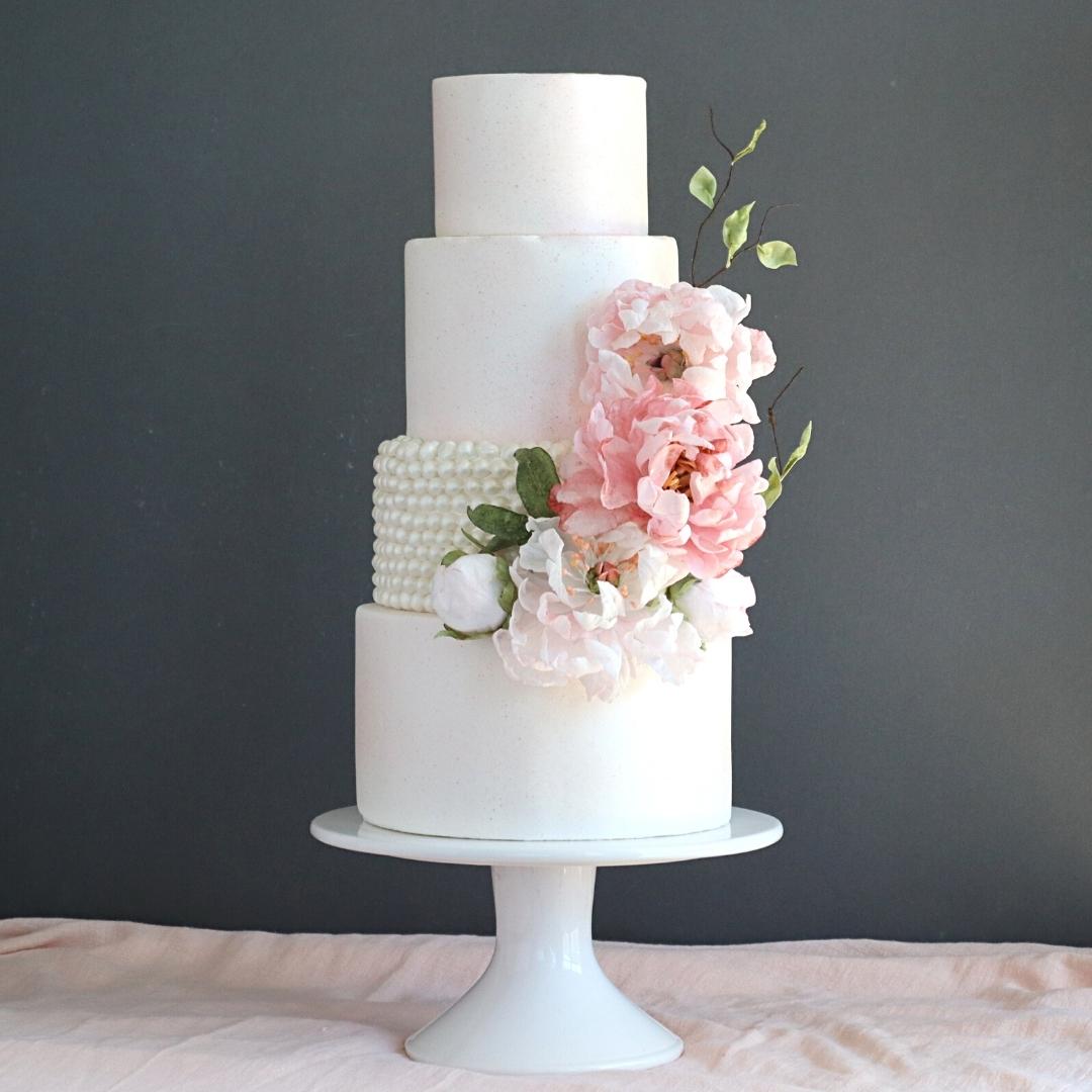 Pink wafer paper flowers on a modern white wedding cake by Florea Cakes